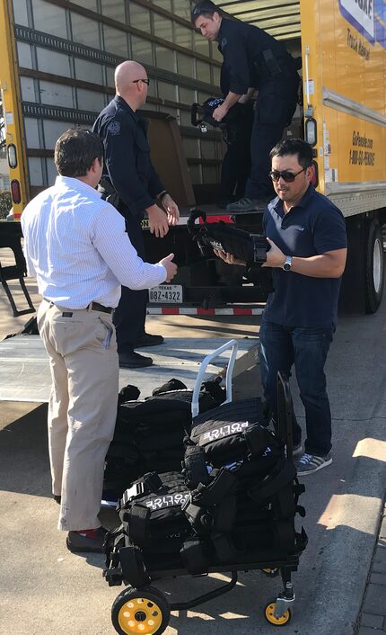 At the southeast patrol division on Wednesday, volunteers and Dallas police officers unload...