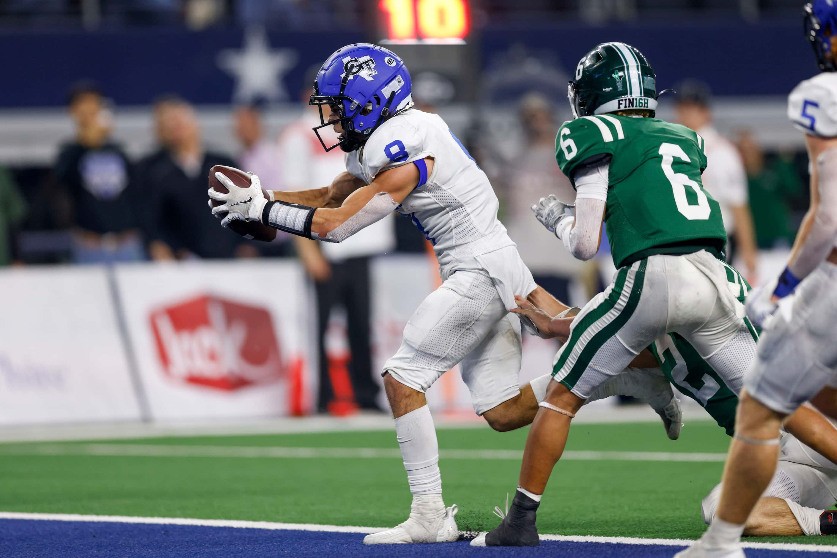 Gunter running back Ethan Sloan (8) stretches the ball across the goal line for a touchdown...