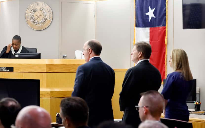 Fired Dallas police Officer Amber Guyger (right) listens as Assistant District Attorney...