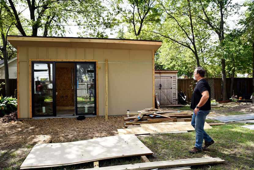 Jody Dean looks over the progress on what will become a studio in his backyard.