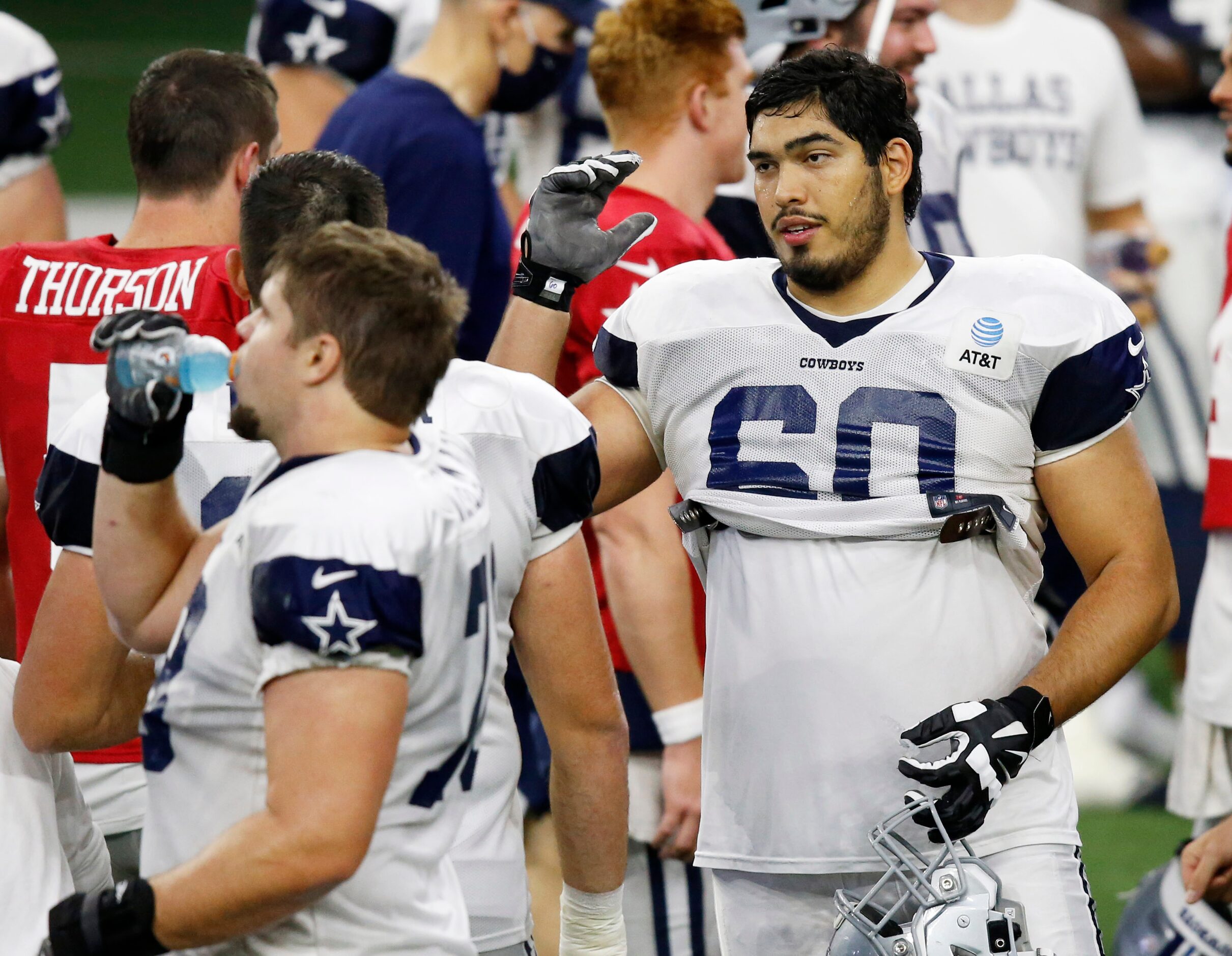 Dallas Cowboys offensive tackle Isaac Alarcón (60) talks with Dallas Cowboys offensive...