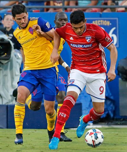 FC Dallas forward Cristian Colman (9) battles for the soccer ball with Colorado Rapids...