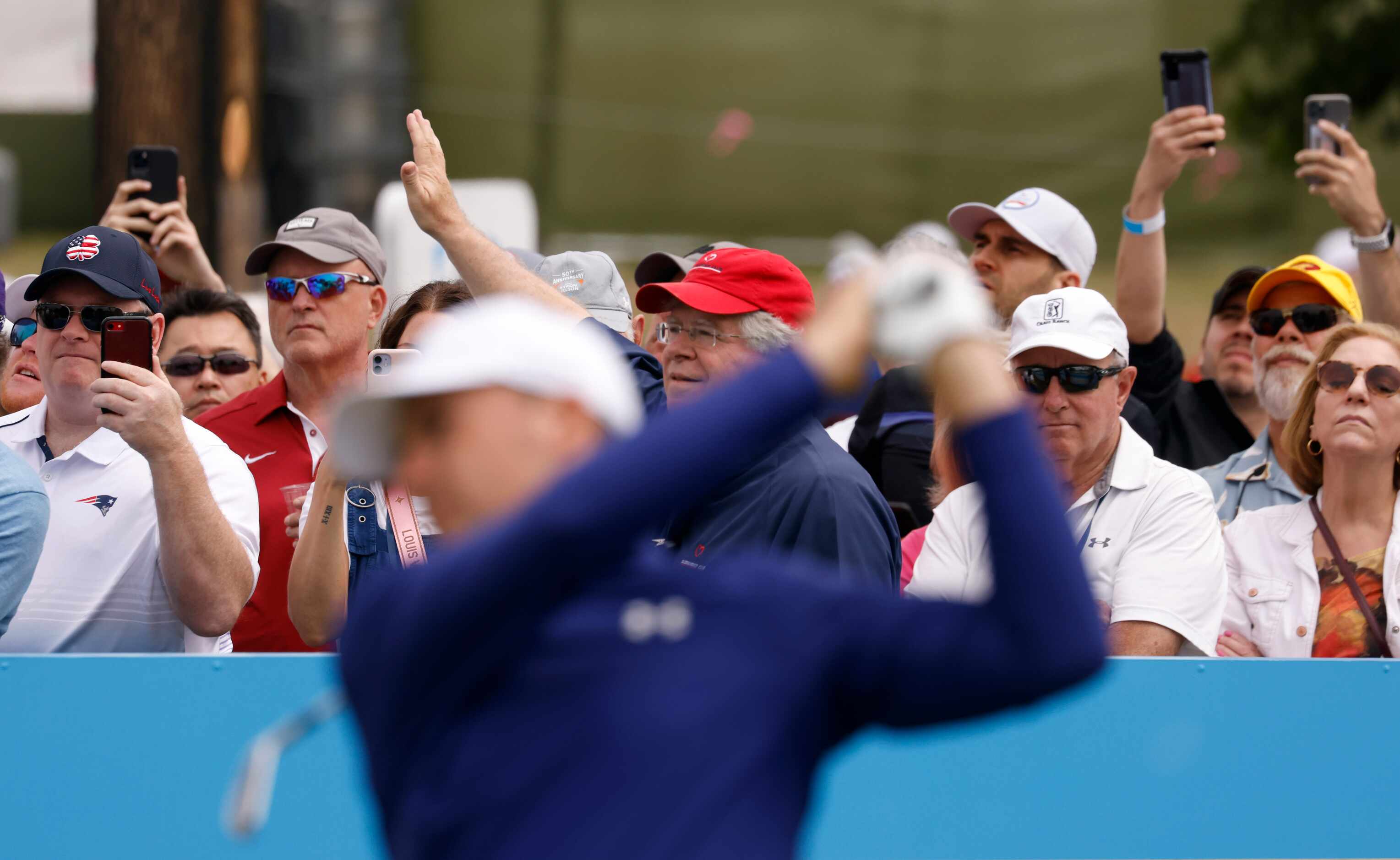 Some fans watch the path of Jordan Spieth's ball as others Fans record Spieth on the 7th tee...