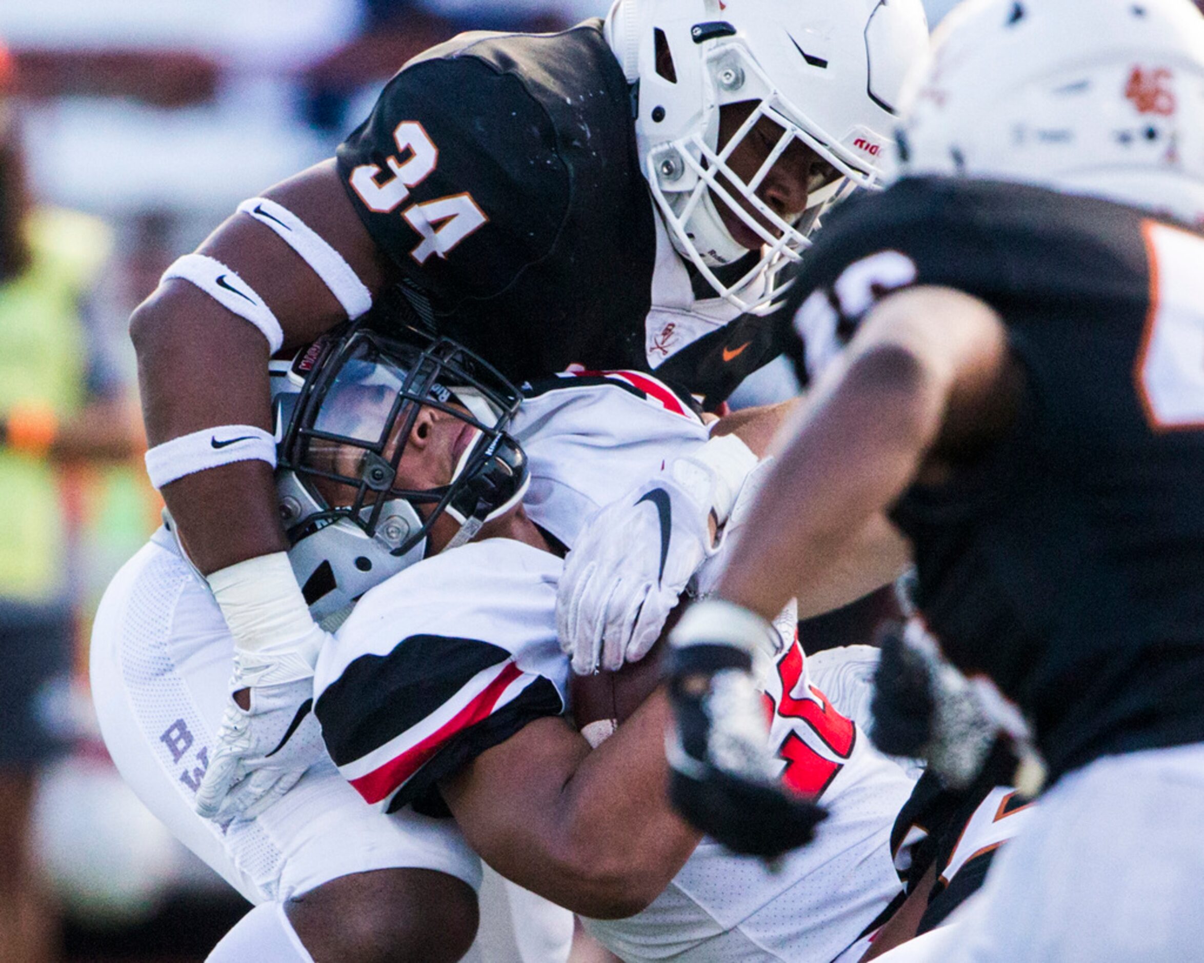 Flower Mound Marcus running back Ty'son Edwards (22) is tackled by Arlington Bowie...