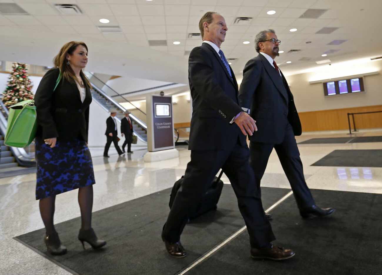 Special prosecutors Nicole DeBorde (left) Brian Wice (center) and Kent Schaffer leave the...