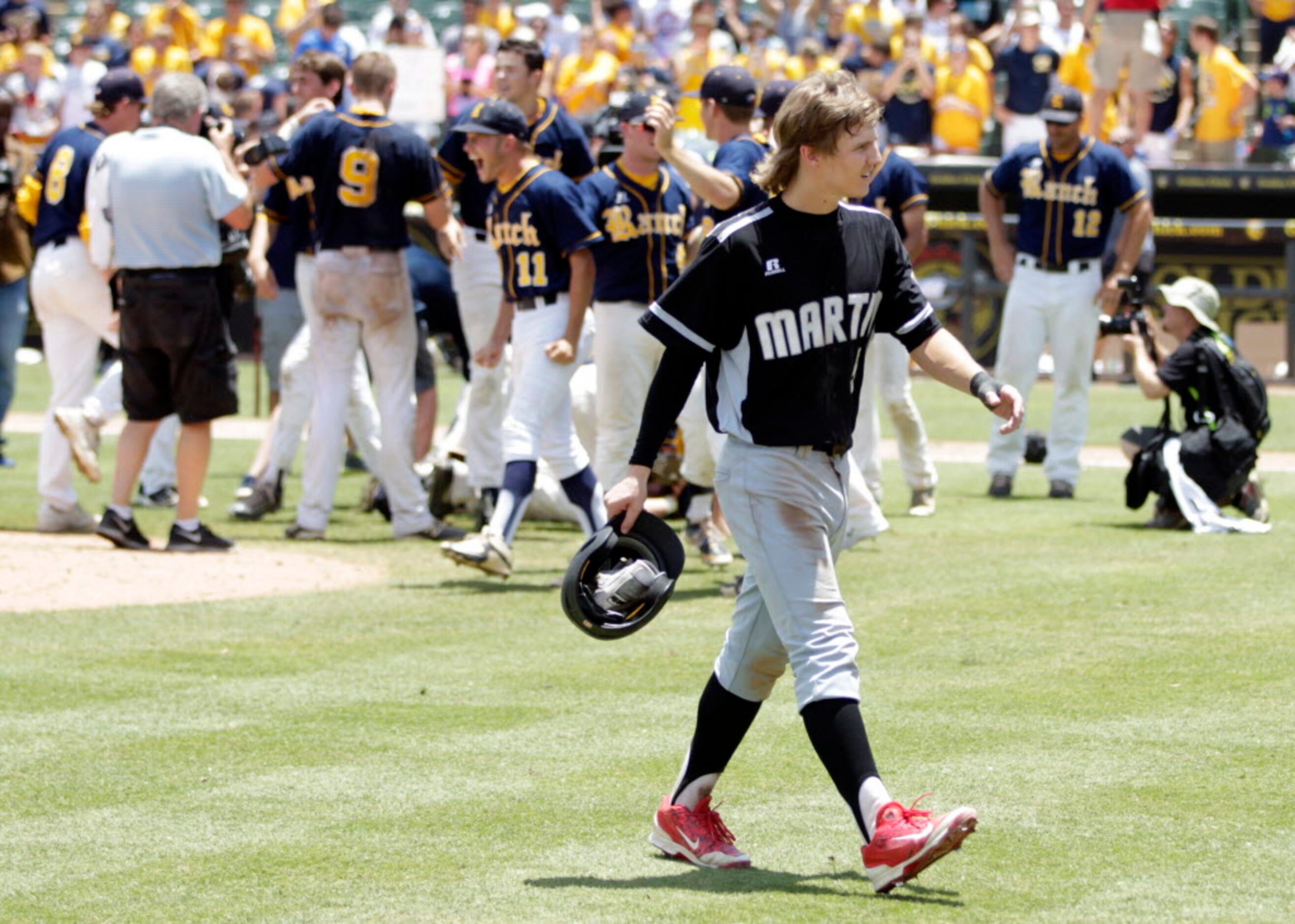 Martin's Grant Jones makes his way to the dugout as Cypress Ranch celebrates their victory...