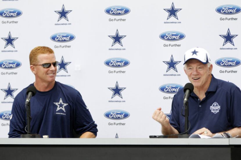 Dallas Cowboys head coach Jason Garrett looks on as Dallas Cowboys owner Jerry Jones answers...