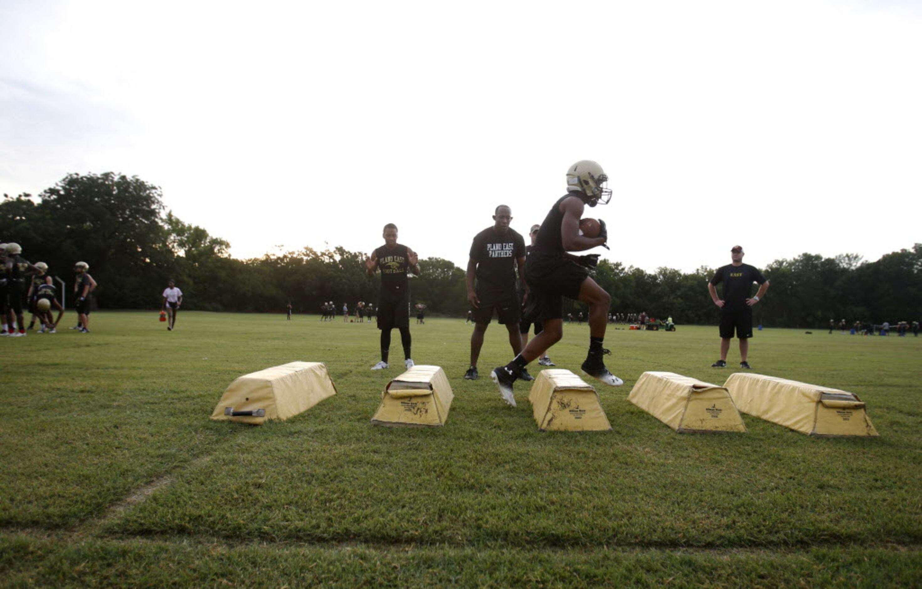 Plano East's running back Jaquawan Douglas runs through a drill during the first day of...