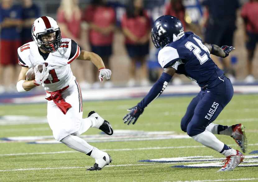 Flower Mound Marcus' Jake Nelson (11) looks to pass Allen's Colton Manning (24) during the...