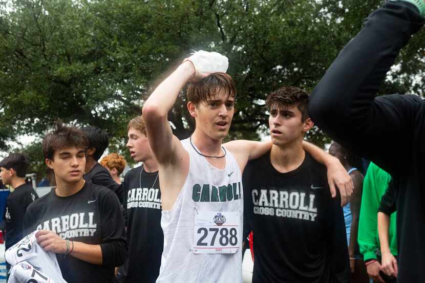 Zach Troutman of the Southlake Carroll Dragons meets with teammates after running in the 6A...