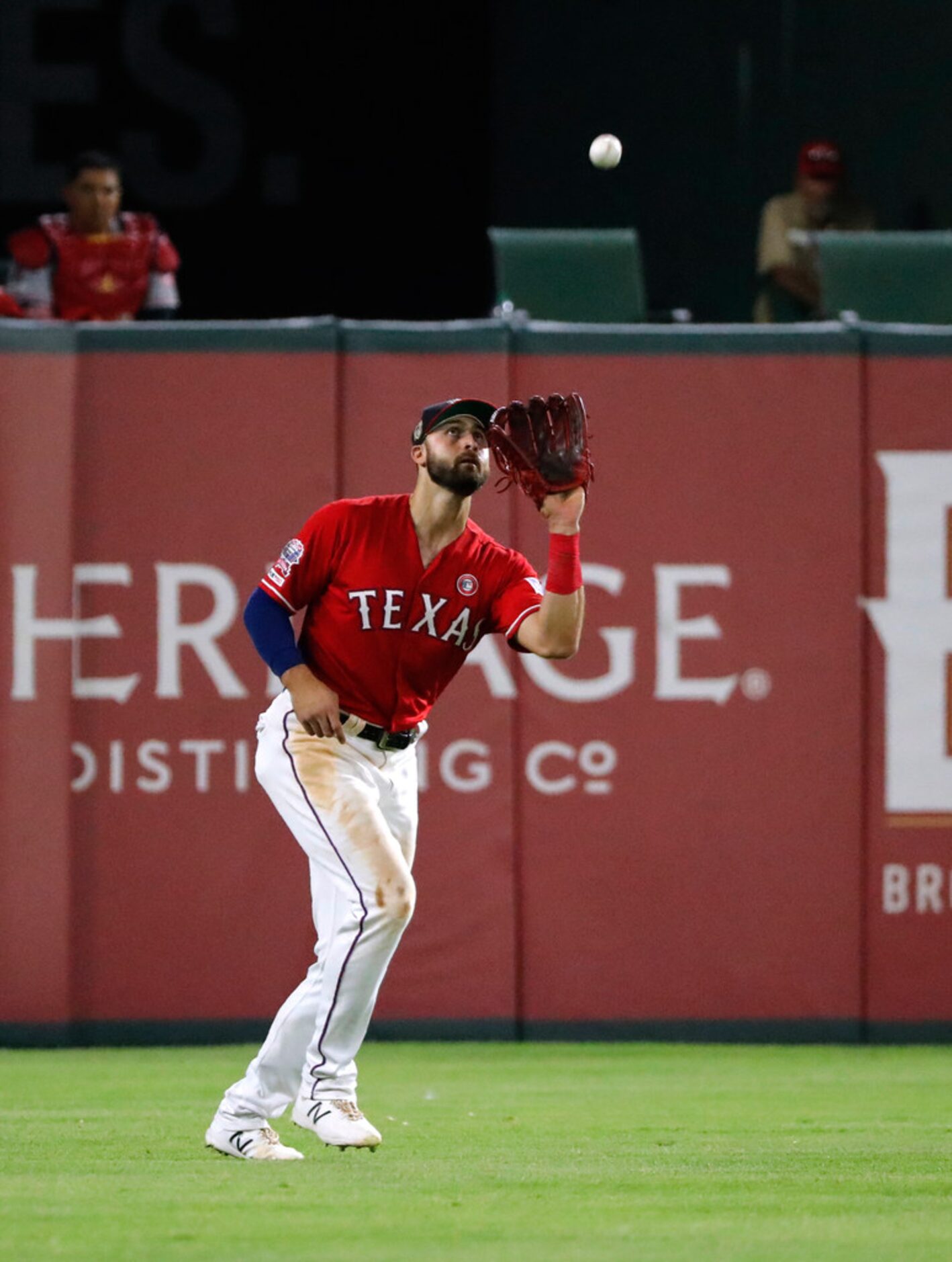 Texas Rangers center fielder Joey Gallo reaches up to catch a fly ball by Los Angeles...