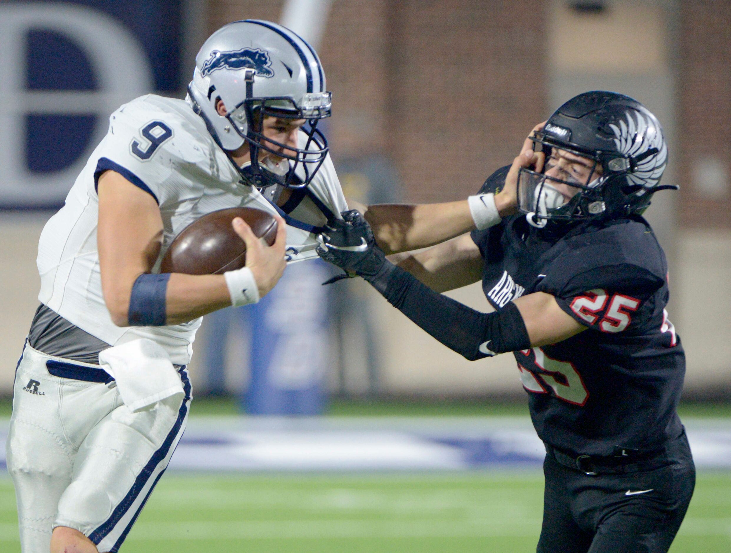 Paris’ Luke Hohenberger (32) tries to fight through a tackle attempt by Argyle’s Hunter...