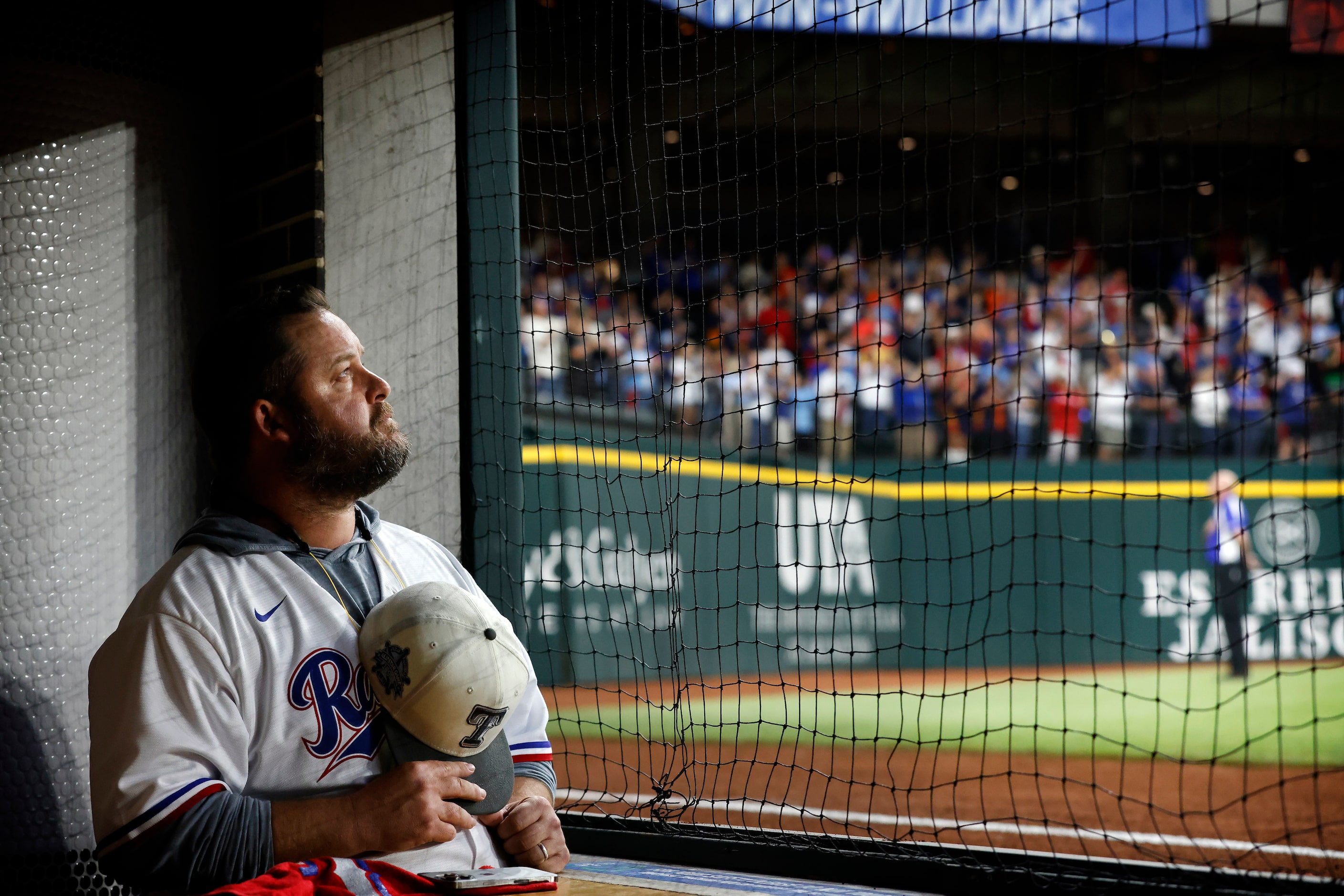 Texas Rangers fan Jason Hodgson of Ennis, Texas takes off his cap for the singing of the...