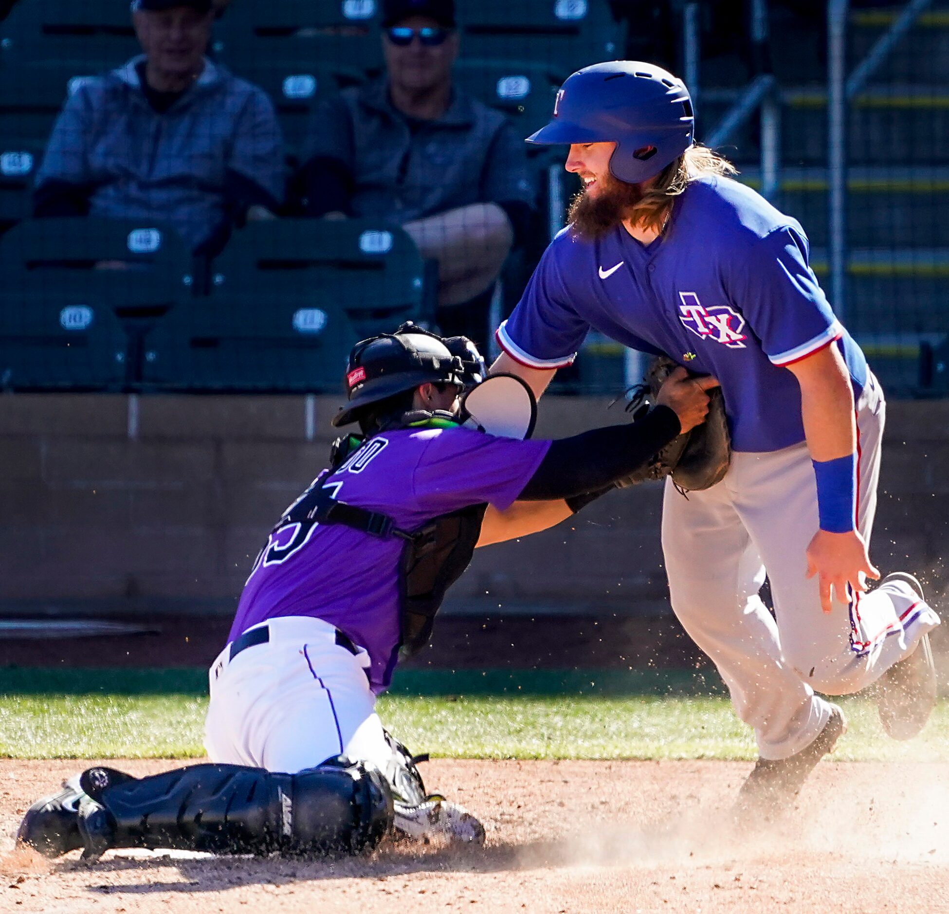 Texas Rangers infielder Davis Wendzel is out at home as Colorado Rockies catcher Chris...