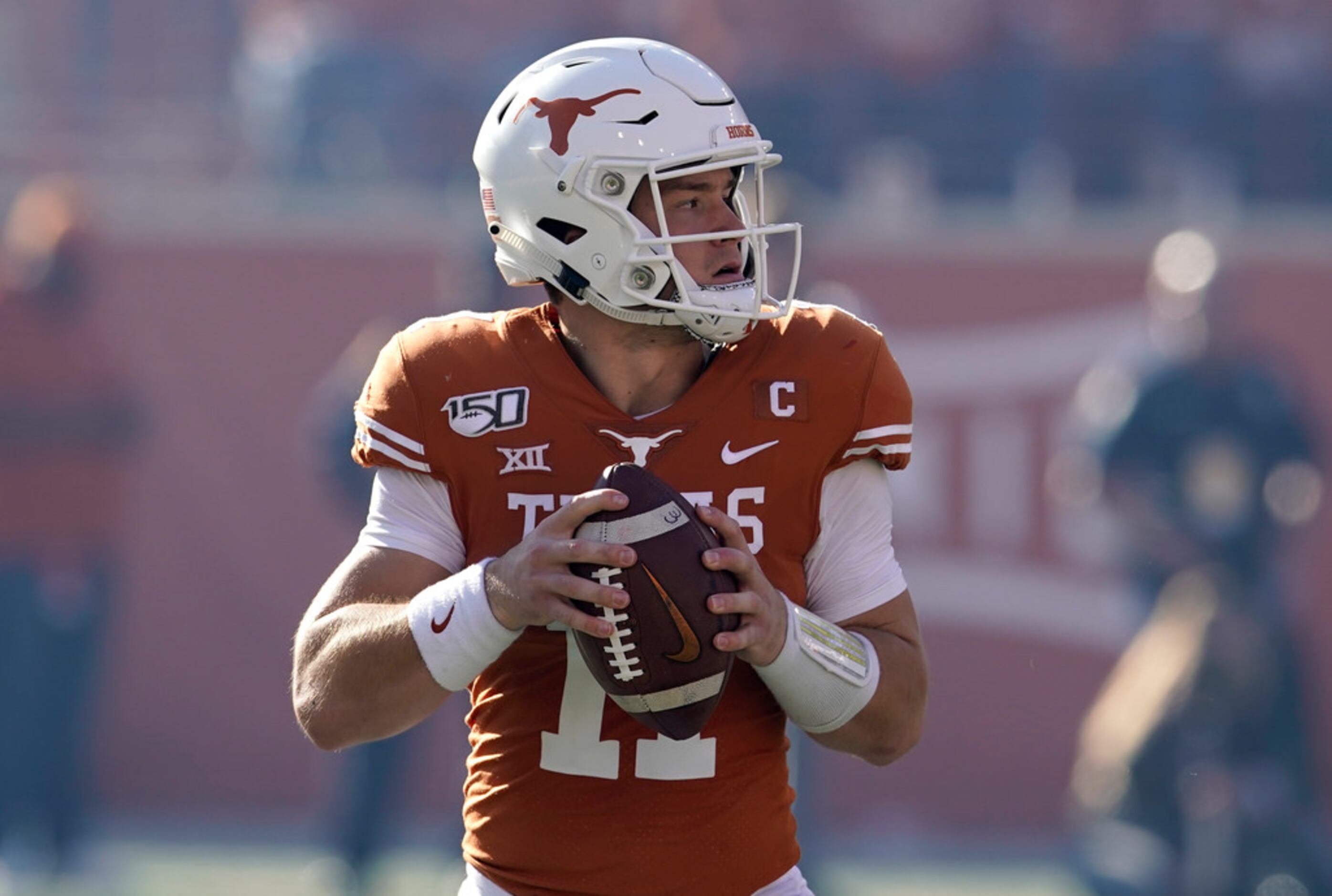 Texas' Sam Ehlinger (11) looks to pass against Kansas State during the first half of an NCAA...