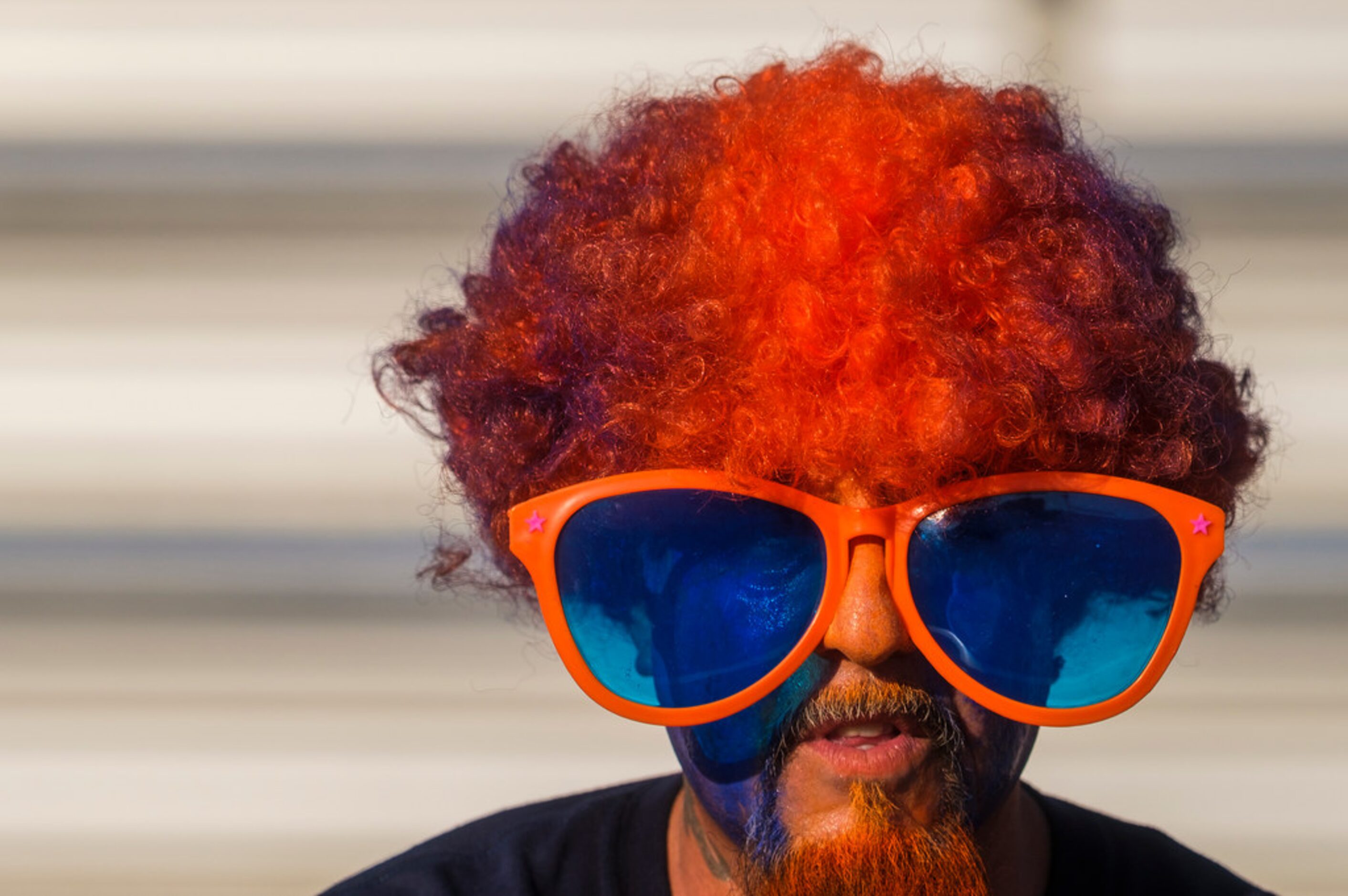 A Sachse fan sports the team colors in the stands during the first half of a high school...