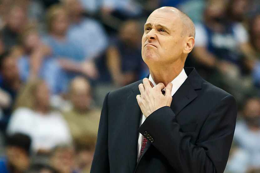 Dallas Mavericks head coach Rick Carlisle adjusts his collar after calling for a timeout...