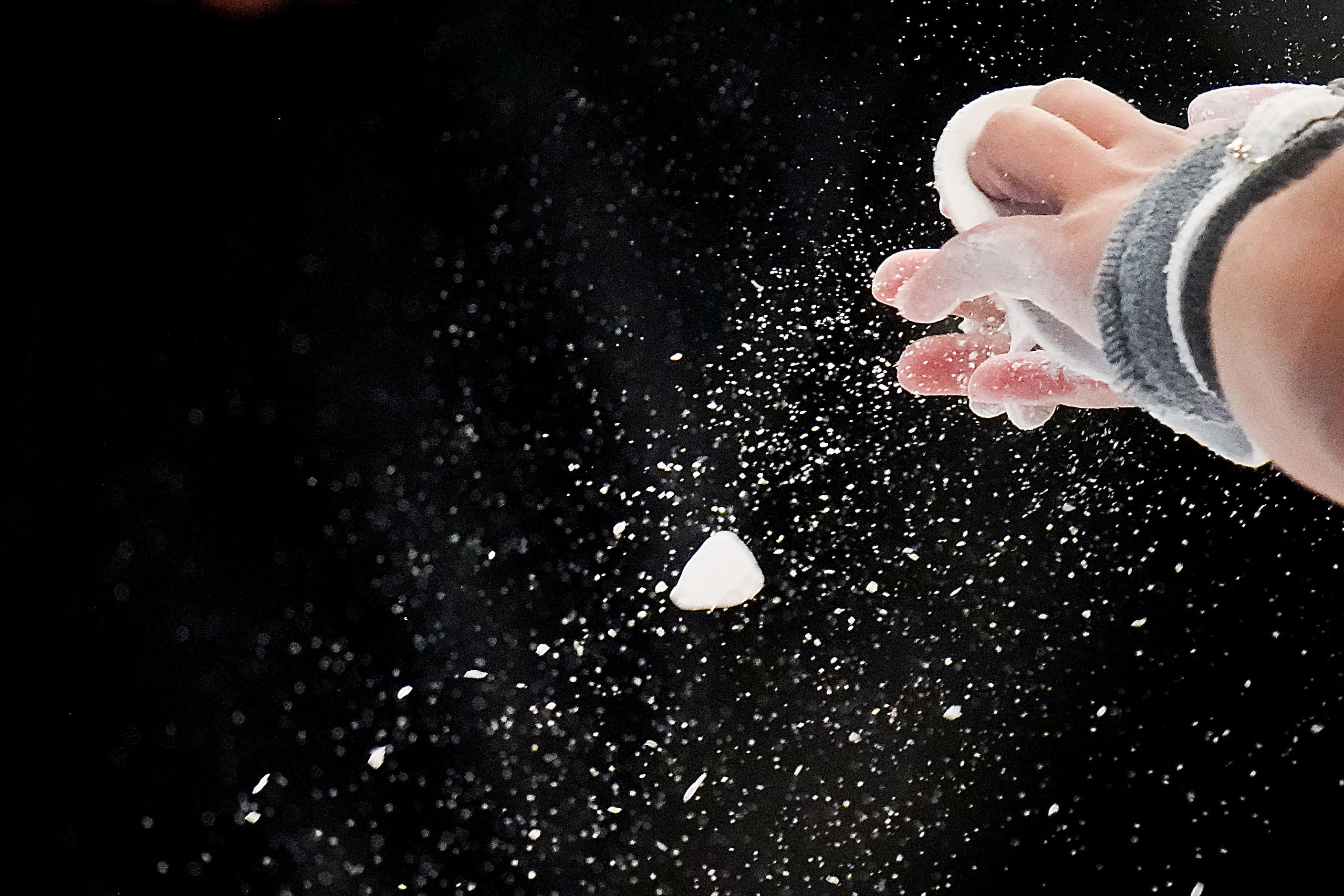 Skye Blakely chalks her grips before she competes on the uneven bars during the U.S....