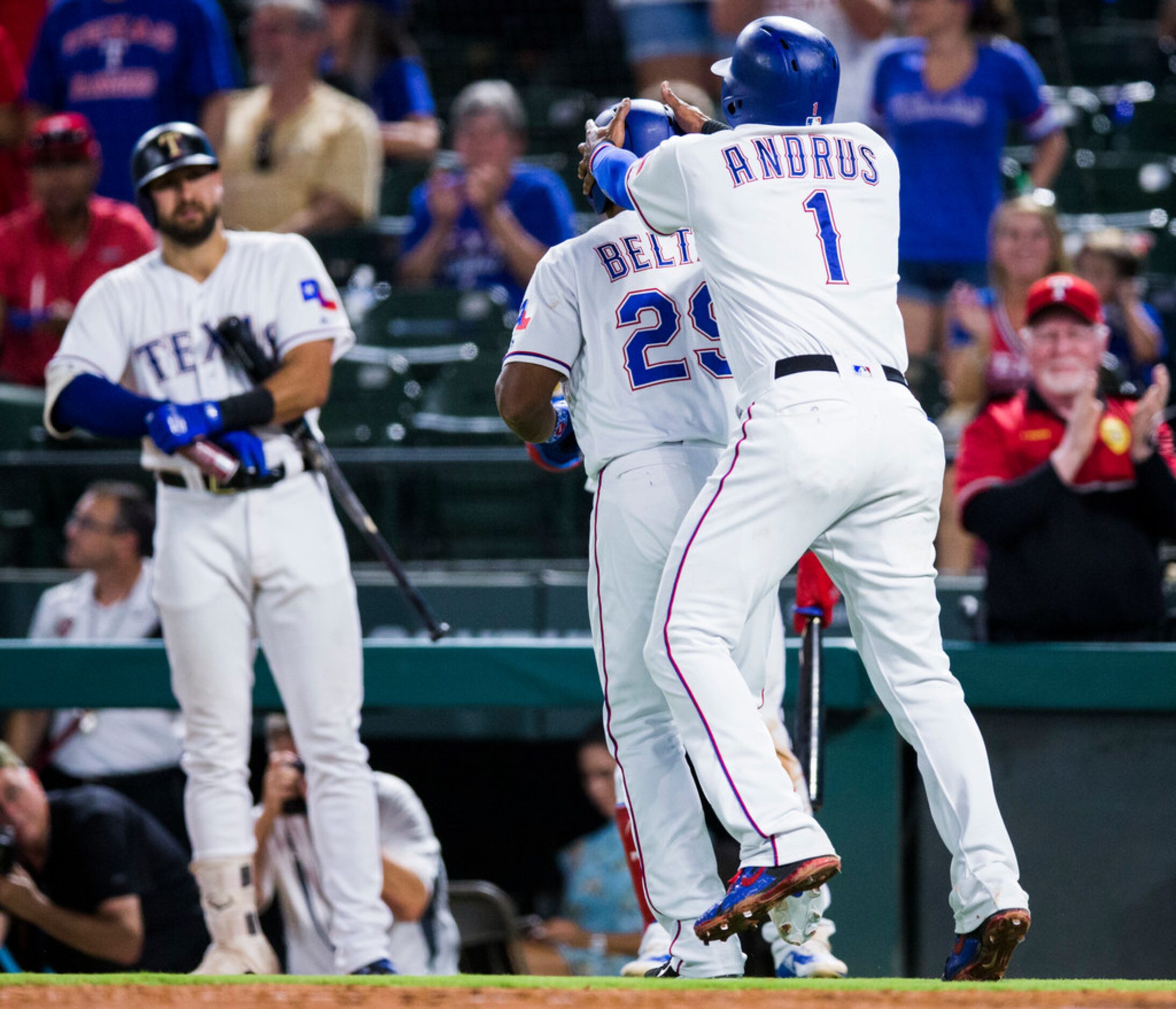 Texas Rangers shortstop Elvis Andrus (1) steals the helmet of third baseman Adrian Beltre...