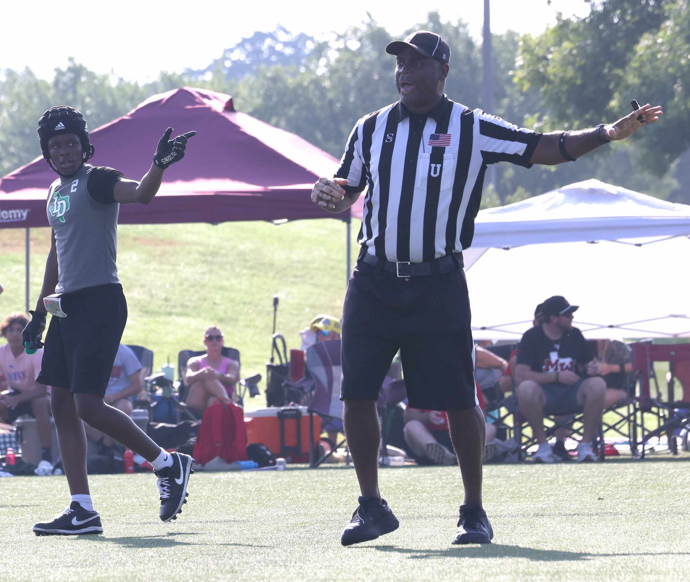 Lake Dallas defensive back DJ Hicks (2) helps a game official make a call during 2nd half...