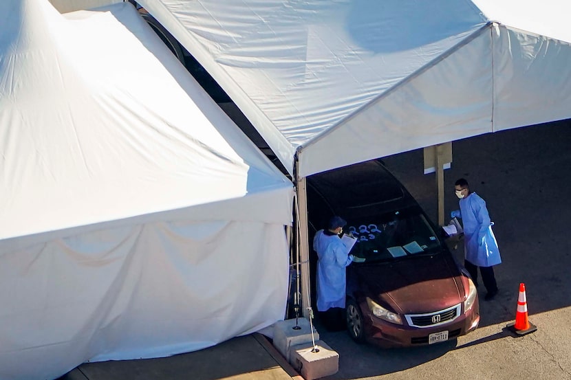 Aerial view of medical professionals working at a Dallas County drive-through COVID-19...