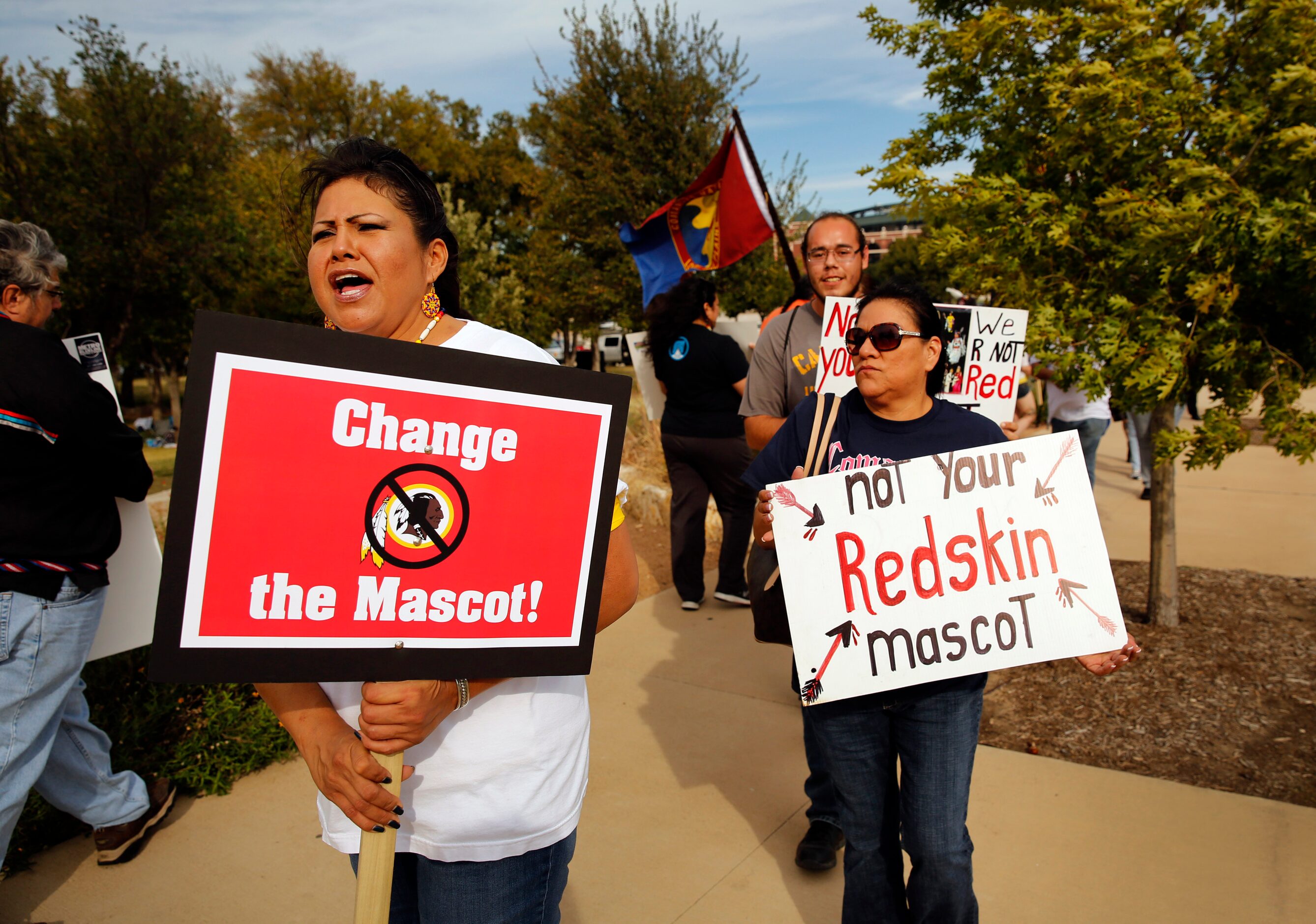 Protest organizer Yolonda Blue Horse (left) leads a couple dozen anti-Redskins protestors...