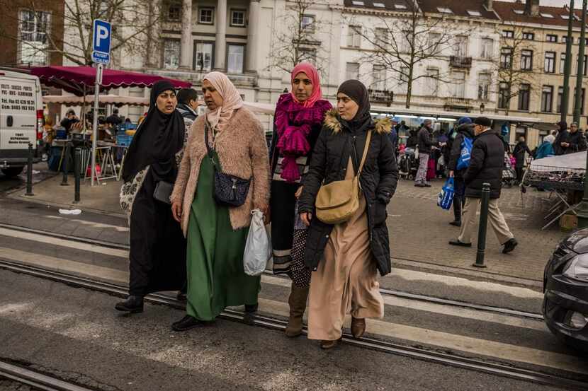 
Residents walk through a market area in the Molenbeek neighborhood of Brussels. A closer...