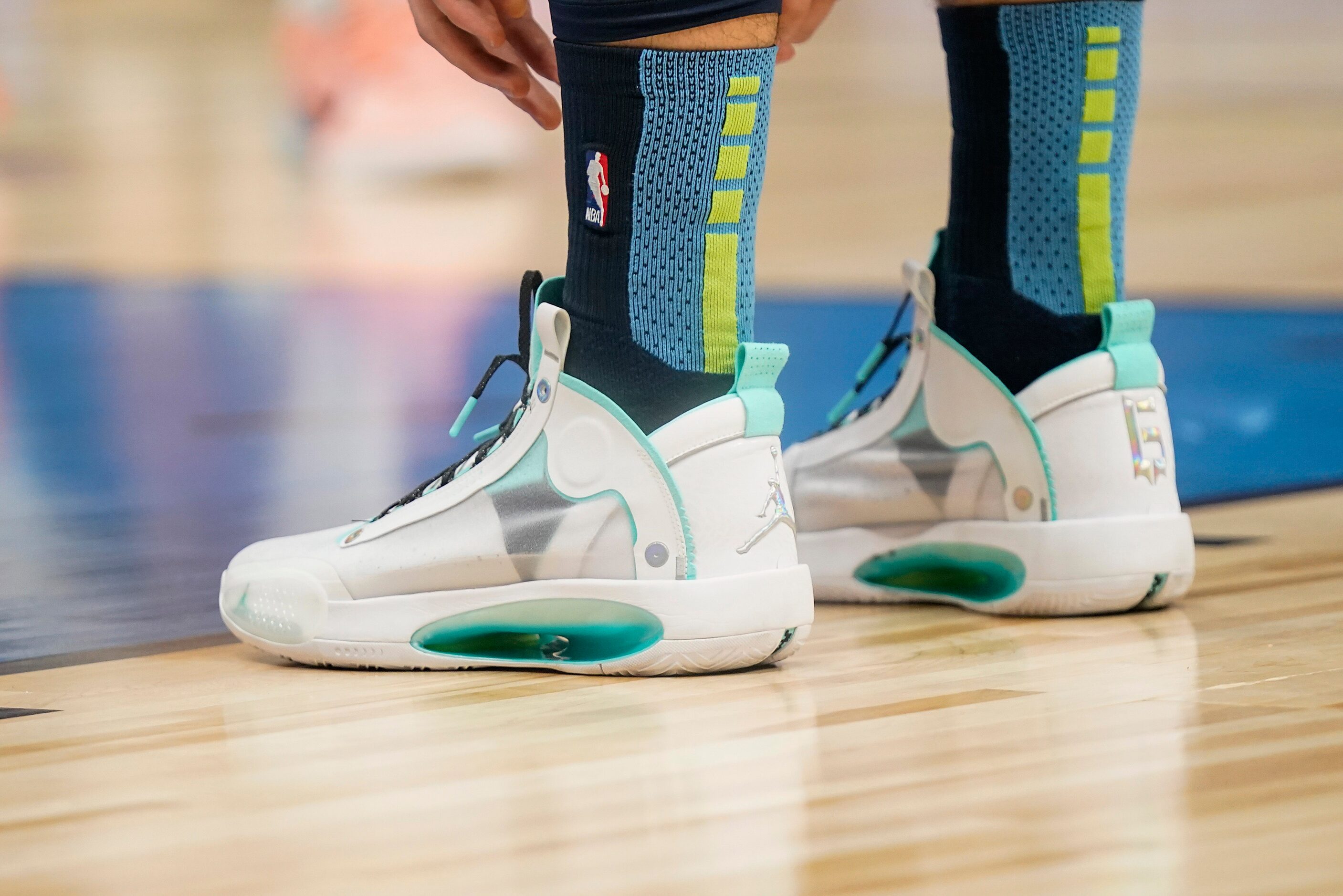 Dallas Mavericks guard Luka Doncic pulls up his socks during the first half of an NBA...