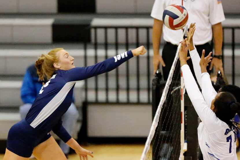 Flower Mound's Angelique Cyr (left) hits a shot during a three-set sweep of Denton Guyer on...