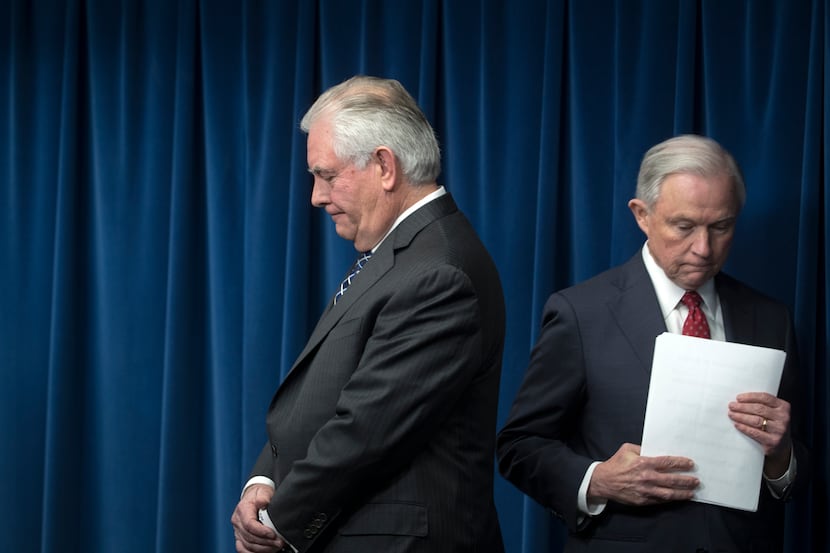 Secretary of State Rex Tillerson and Attorney General Jeff Sessions wait to speak at a...