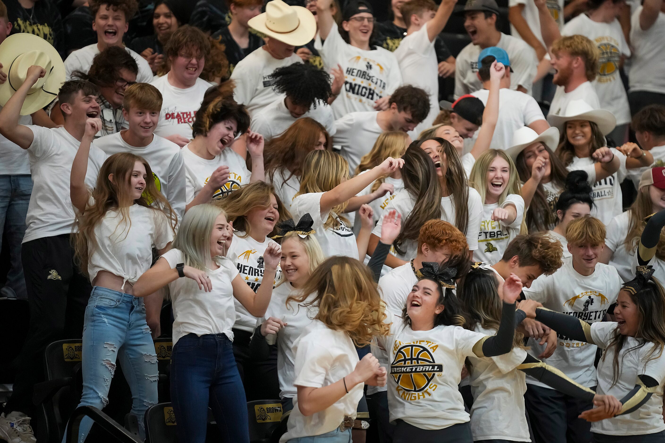 Students cheer during a performance in honor of special surprise guest Troy Aikman during a...