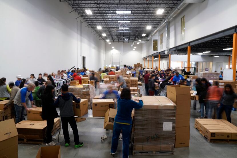More than 100 members of Hunger Mitao came out to volunteer at the North Texas Food Bank in...