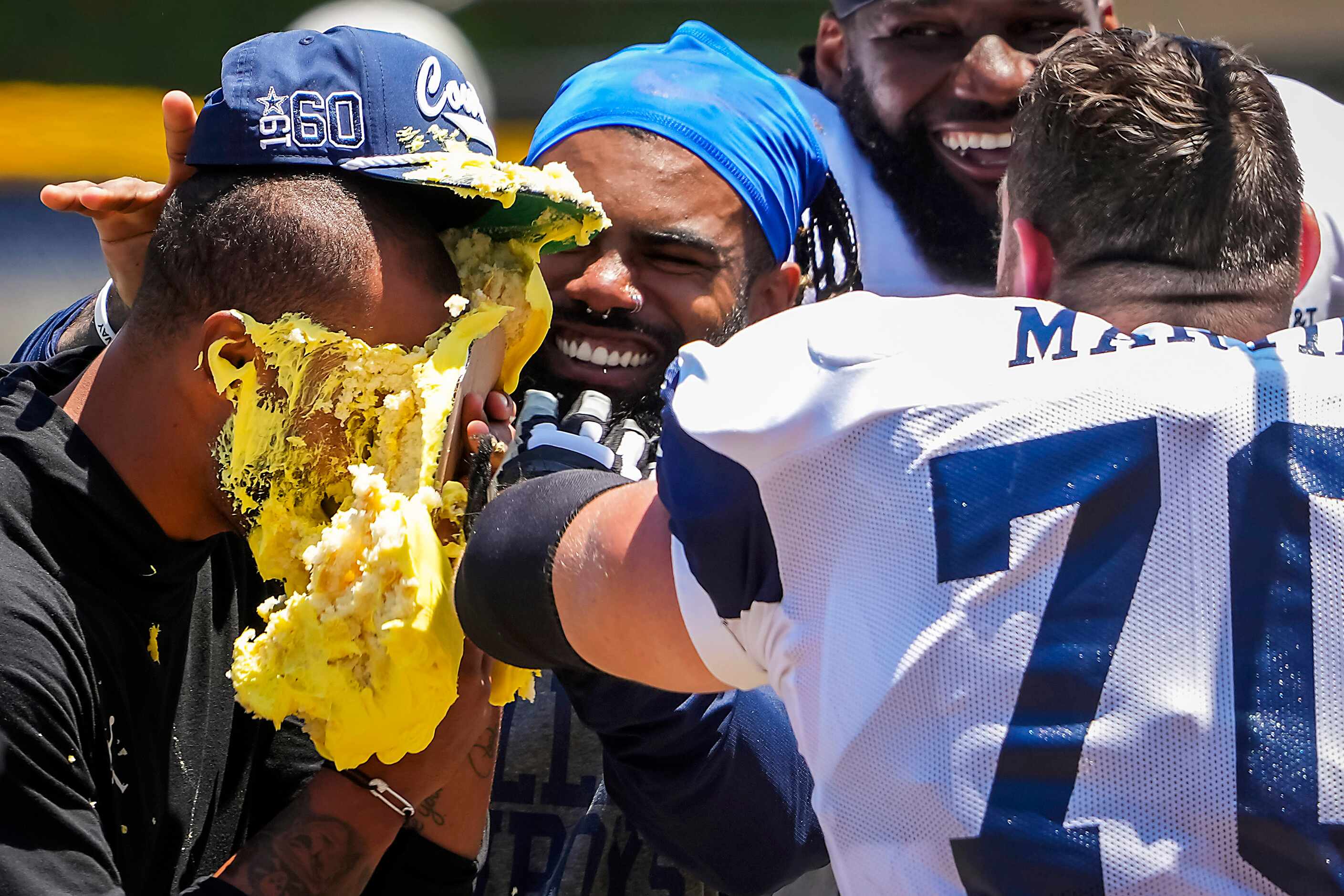 Dallas Cowboys quarterback Dak Prescott gets a cake to the face from his teammates,...