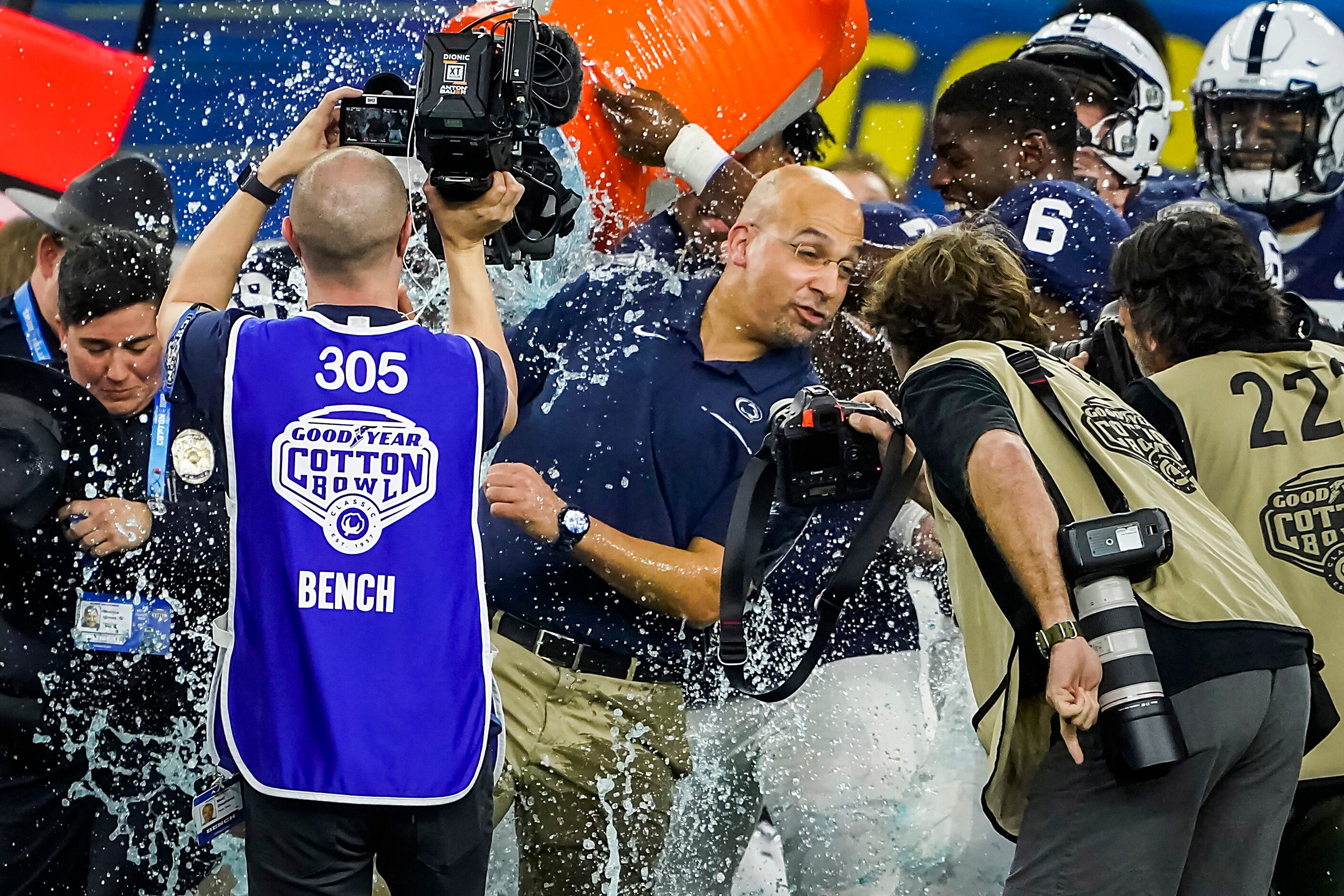 Penn State players turn a bucket of water head coach James Franklin in celebration as time...