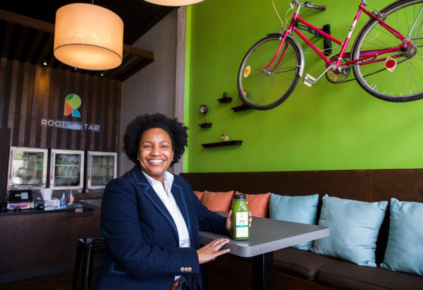 Owner Nicole Allen poses for a portrait inside Roots on Tap across the street from Fair Park...