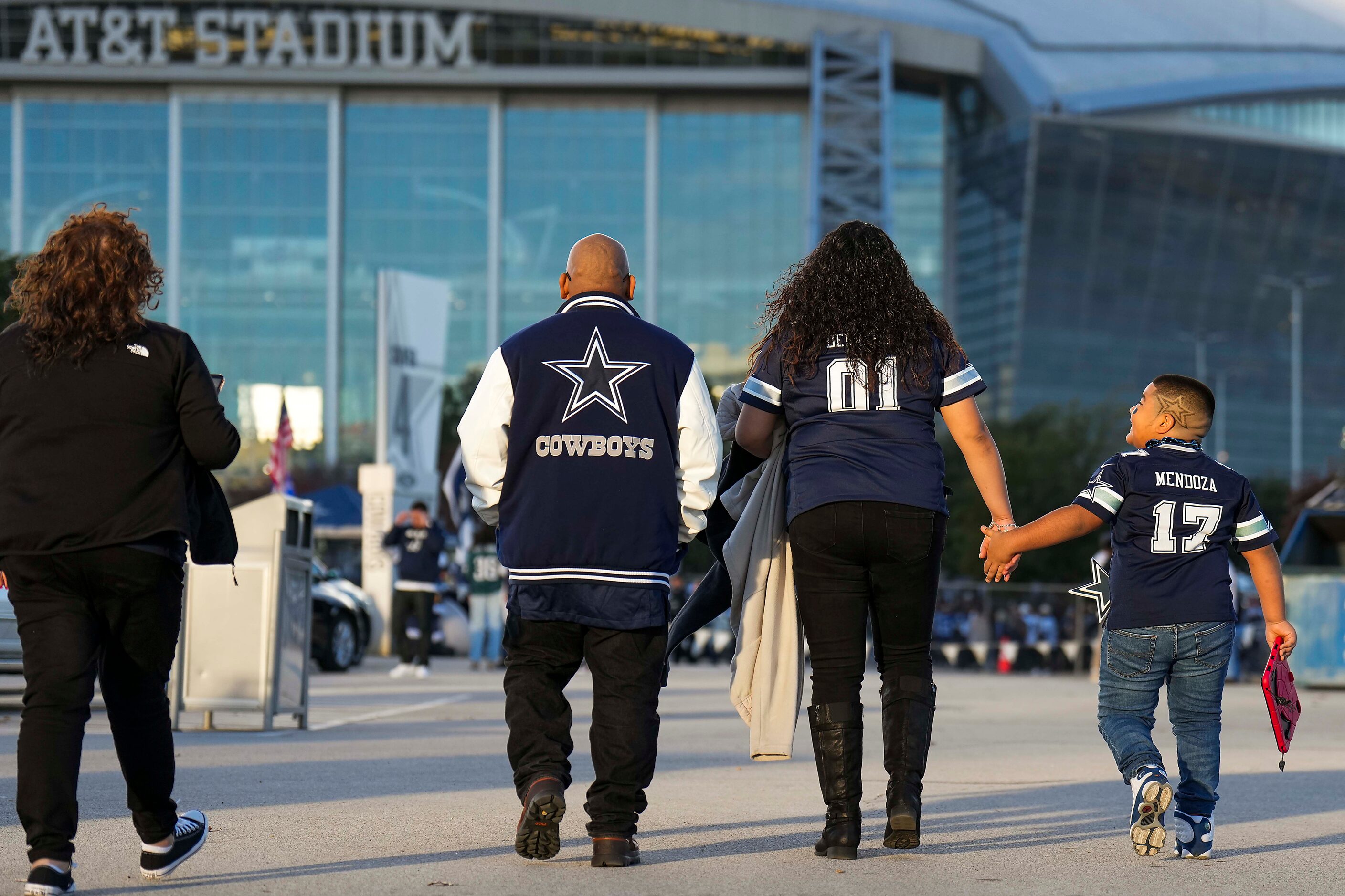 Fans head to the stadium before an NFL football game between the Dallas Cowboys and the...