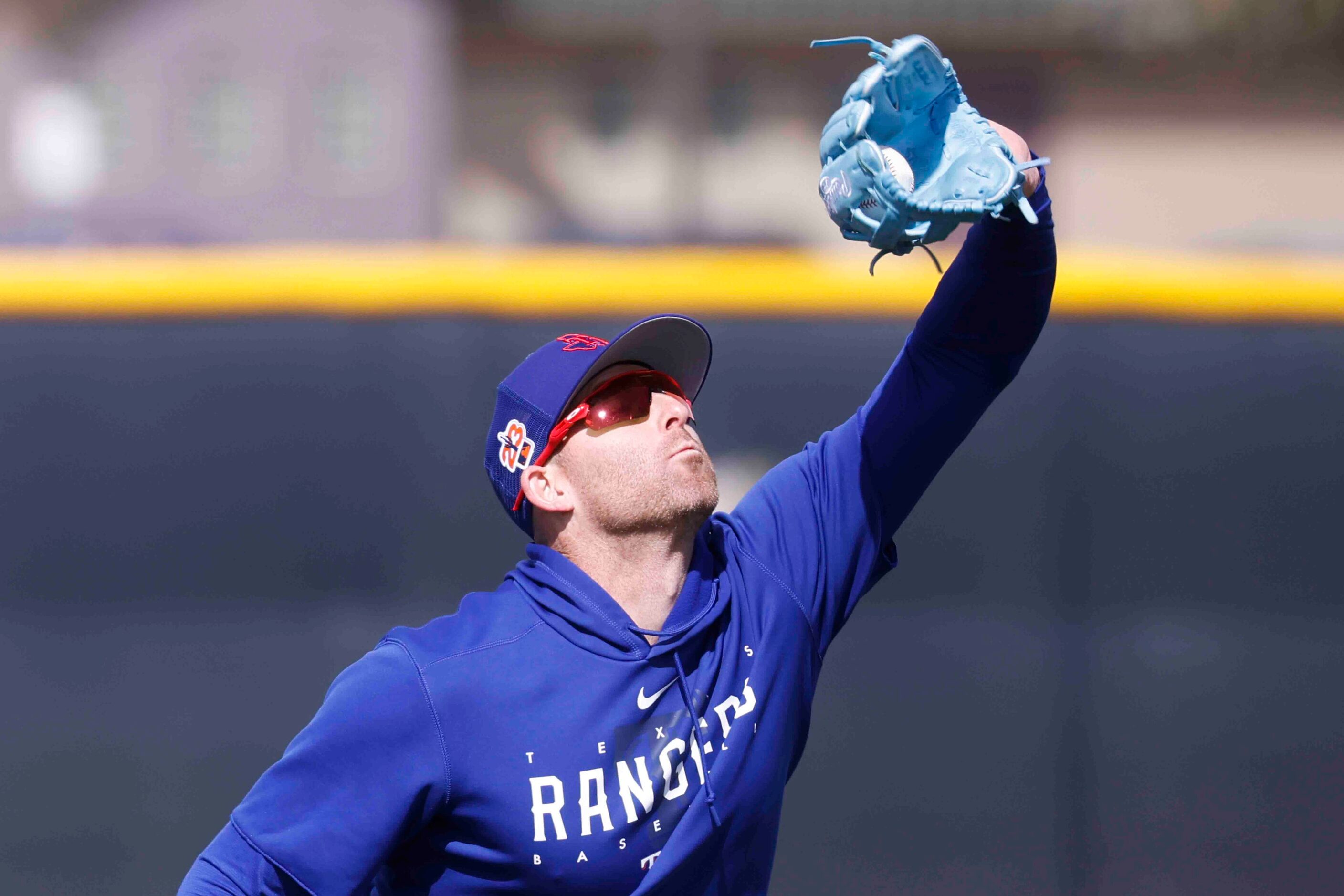 Texas Rangers outfielder Brad Miller makes a catch during a drill at spring training workout...