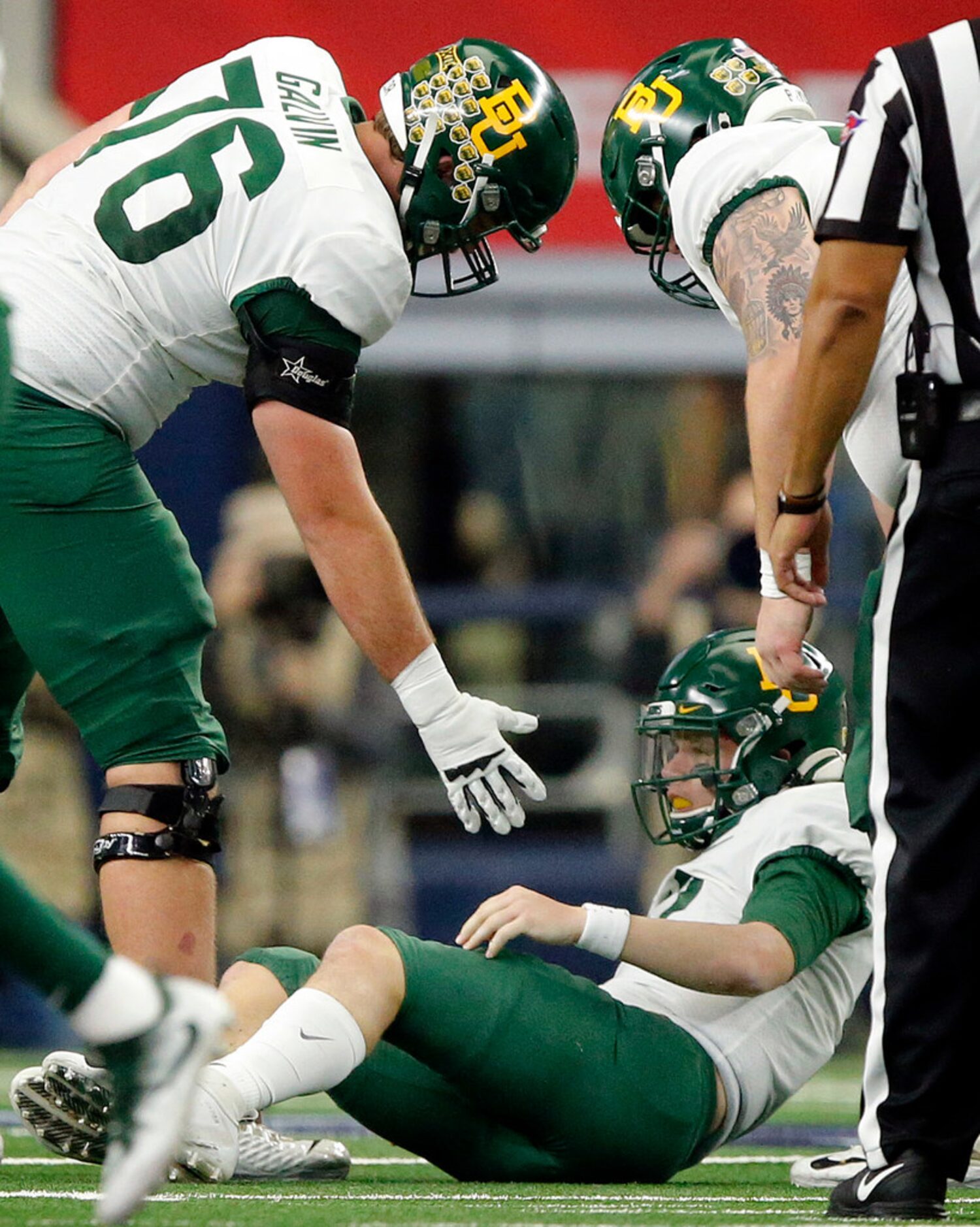 Baylor Bears offensive lineman Connor Galvin (76) extends a hand to quarterback Charlie...