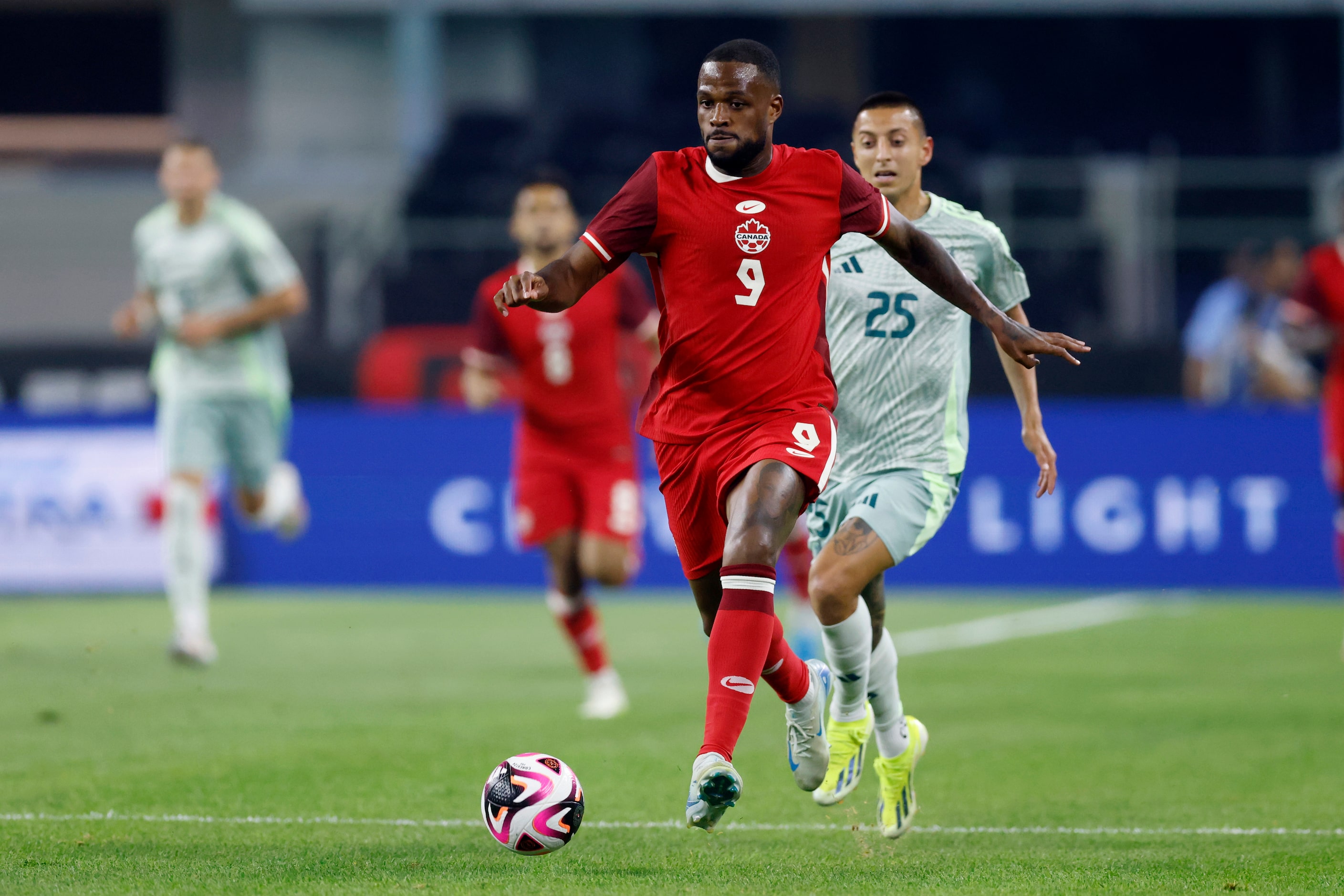 Canada forward Cyle Larin (9) dribbles the ball down the field during the first half of an...