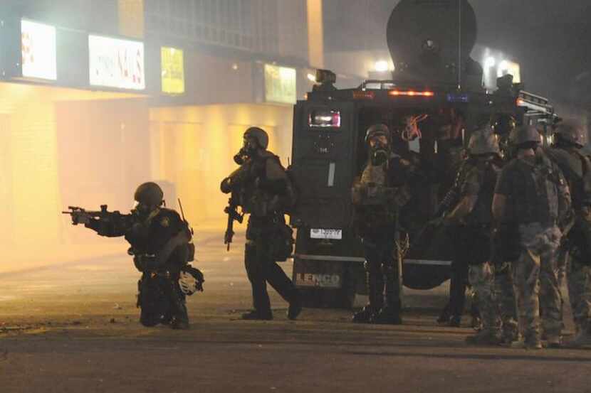
Police fired tear gas canisters as they tried to break up a protest in Ferguson, Mo., in...