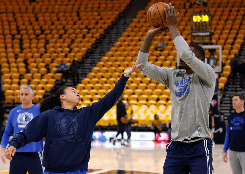 Dallas Mavericks assistant coach Kristi Toliver works with Dallas Mavericks forward Dorian...