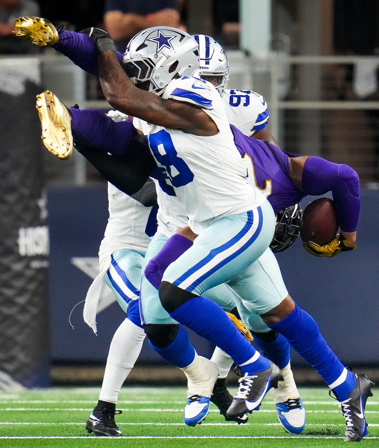 Dallas Cowboys linebacker Damone Clark (18) upends Baltimore Ravens running back Derrick...