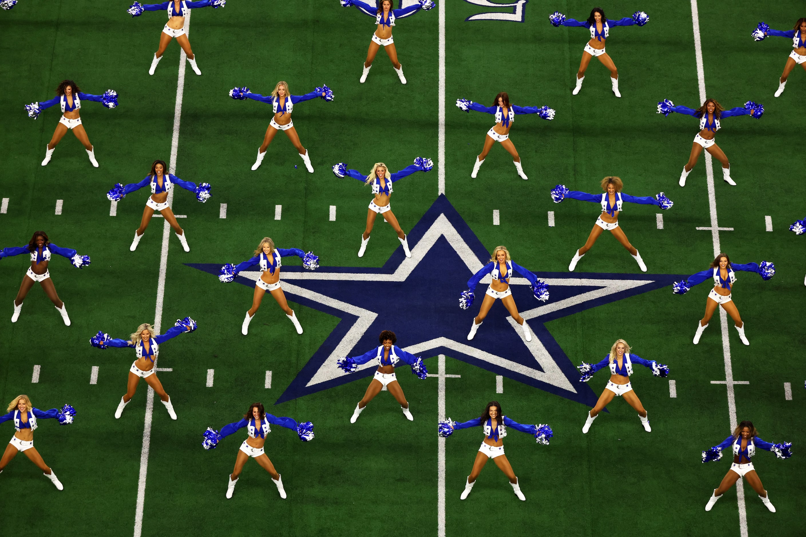 ARLINGTON, TEXAS - SEPTEMBER 11: Dallas Cowboys cheerleaders perform before the game between...