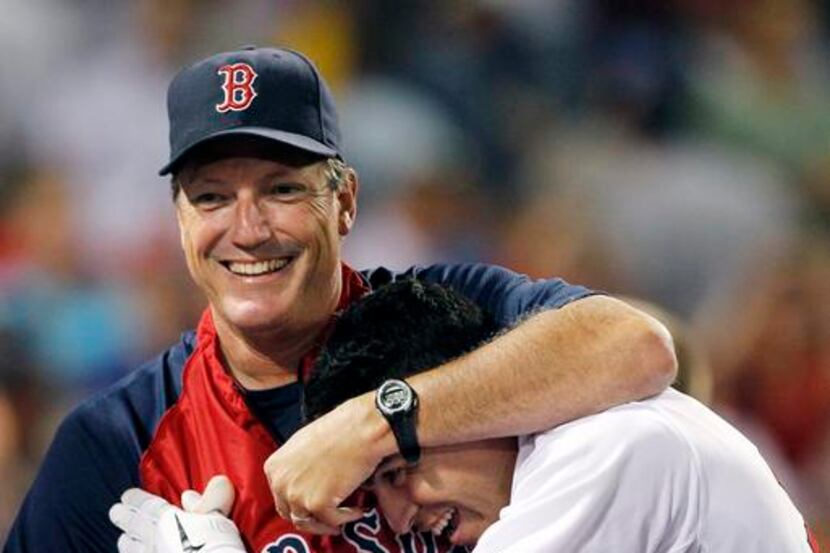 Boston Red Sox's Jacoby Ellsbury is hugged by batting coach Dave Magadan after his home run...