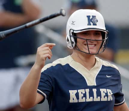 FILE - Keller catcher Hayden Brown (24) smiles as she tosses her bat after drawing a walk in...