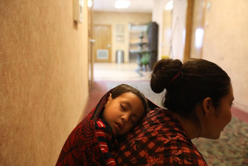 Catarina Juan Francisco and her son, Byron Juan Francisco, from Guatemala, rest in the...