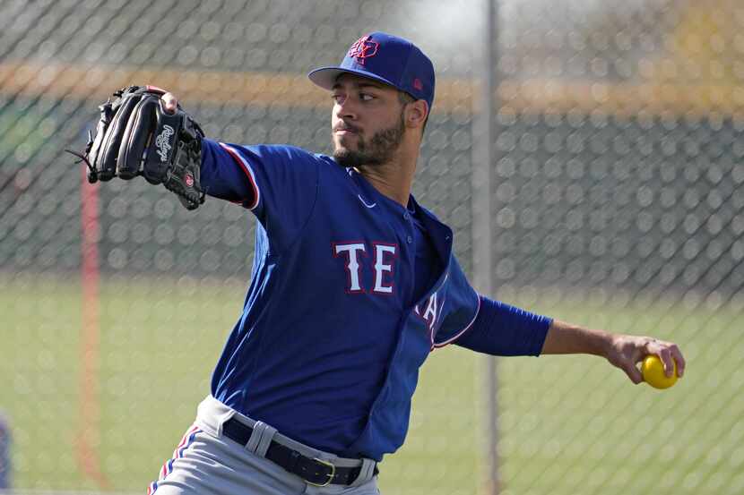 Texas Rangers pitcher Antoine Kelly throws during spring training baseball practice Sunday,...