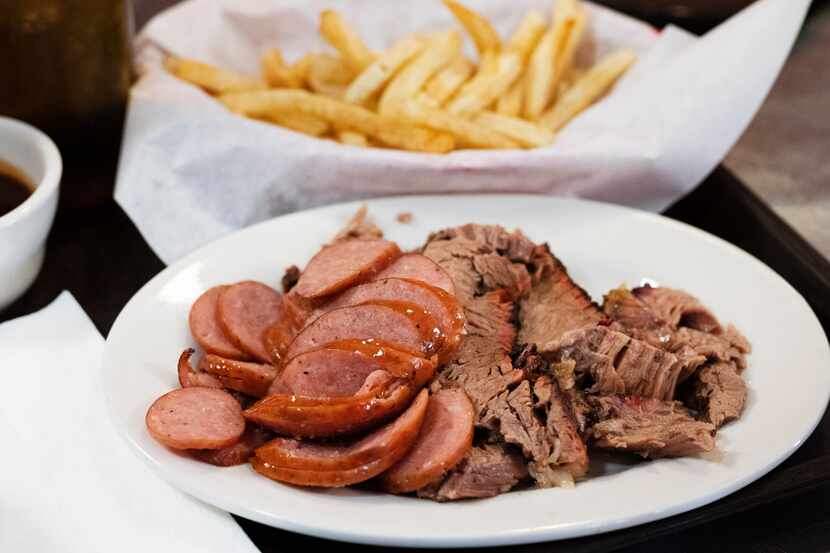 Owner Billy McDonald hands out a two meat combo with brisket and sausage from Mac's...