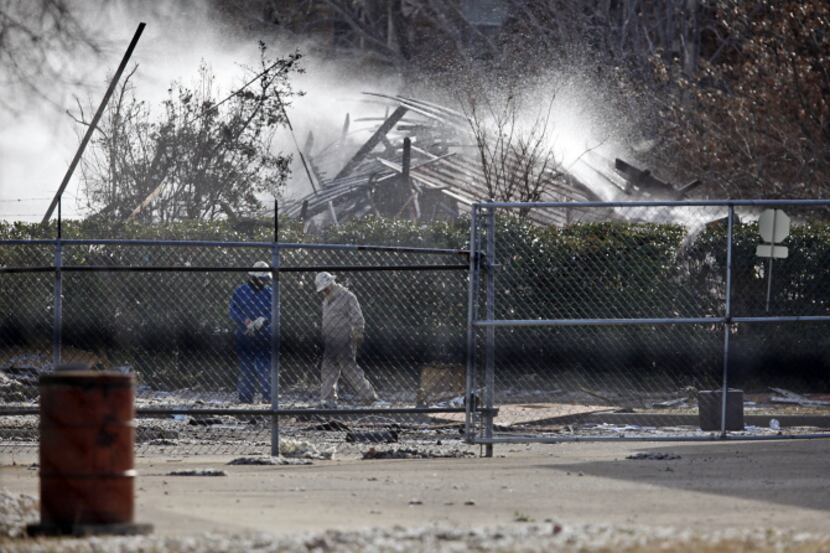 Lewisville firefighters poured water onto the smouldering rubble after the explosion in the...
