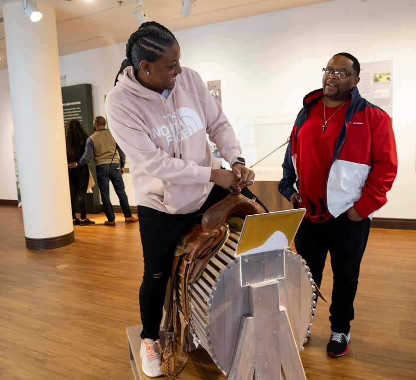 Kim Brown looks at Glen Brown while getting on a saddle in the “Black Cowboys: An American...